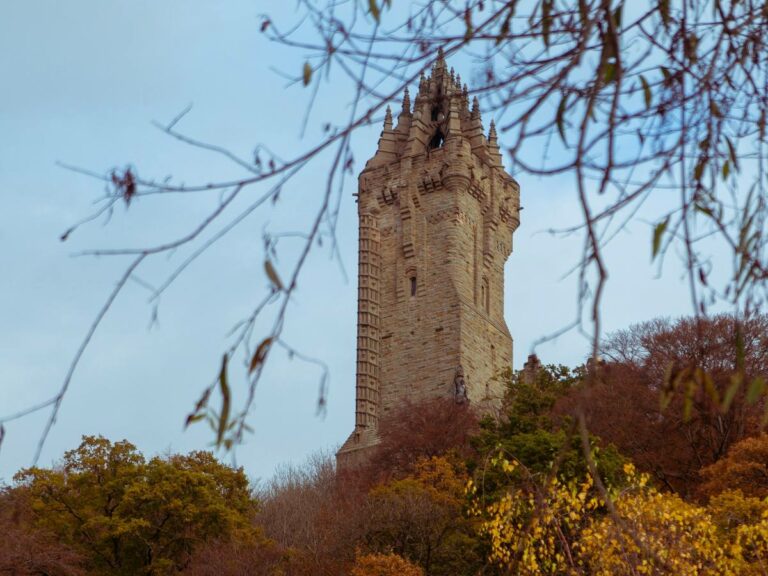 A monument stands tall amongst the Autumn trees.