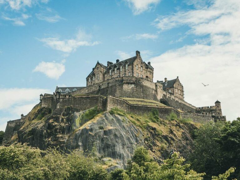 Castle sitting on a rocky outcrop sitting above the city of Edinburgh.