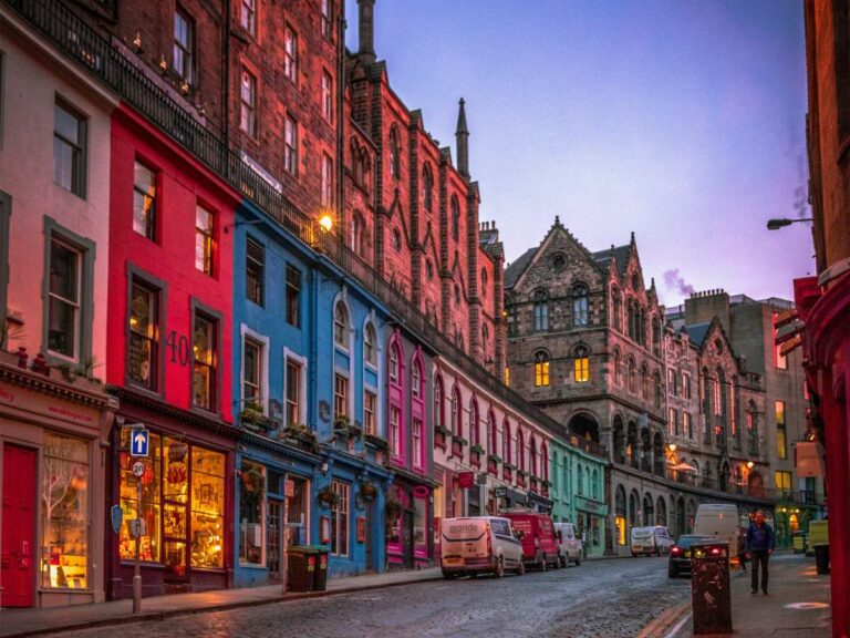 Colourful shopping street at twilight in Edinburgh.