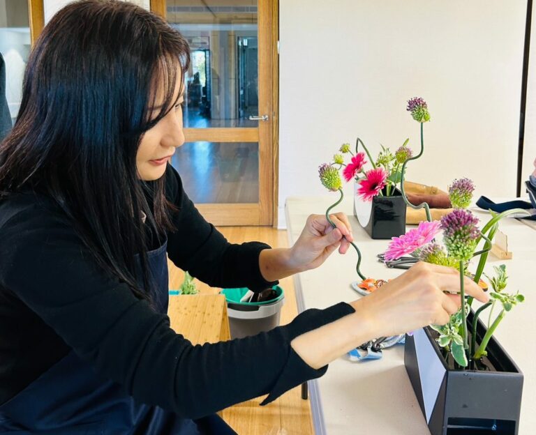 Lady patiently creating Ikebana flower arrangement