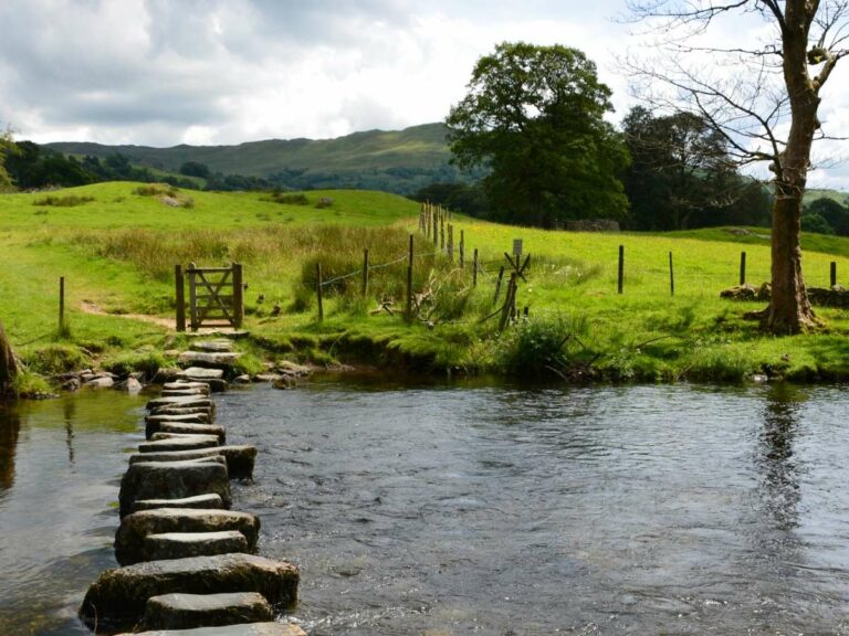 Stepping stone crossing over stream in the countryside on a sunny day.