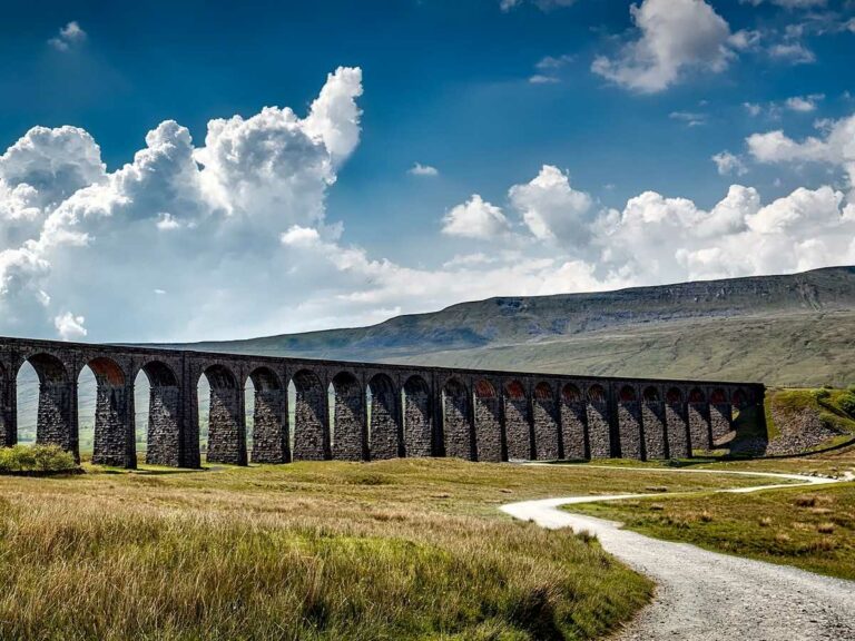 Roman viaduct in Britain, set against a cloudy sky.