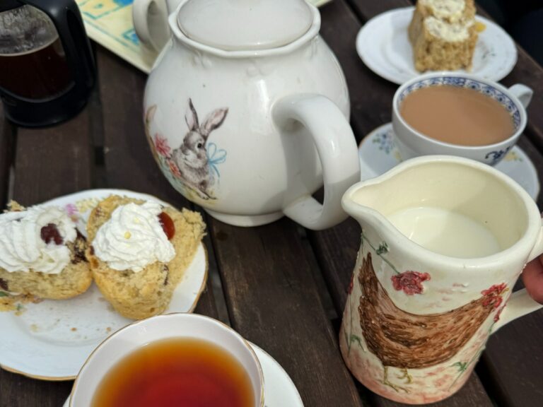 Traditional scones, jam and cream served with tea.